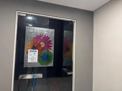 a room with a door with flowers on the wall at Fairlane Bukit Bintang by Lily in Kuala Lumpur