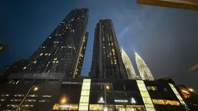 three tall skyscrapers in a city at night at KL Star Residance in Kuala Lumpur