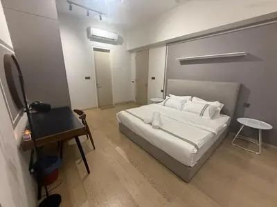 a bedroom with a white bed and a table at KL Star Residance in Kuala Lumpur