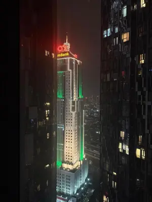 a tall building with red and green lights on it at KL Star Residance in Kuala Lumpur