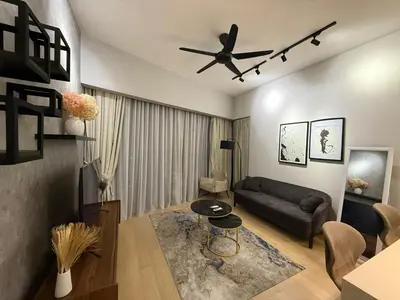 a living room with a couch and a ceiling fan at KL Star Residence KLCC in Kuala Lumpur