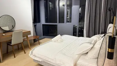 a bedroom with a bed and a desk and a mirror at KL Star Residence KLCC in Kuala Lumpur
