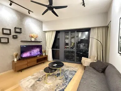 a living room with a couch and a flat screen tv at KL Star Residence KLCC in Kuala Lumpur