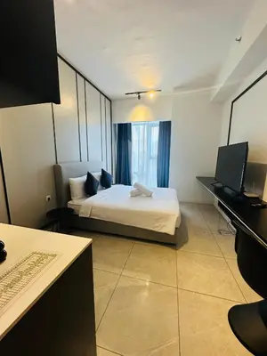 a hotel room with a bed and a piano at Supper Suite By Axon Residence in Kuala Lumpur