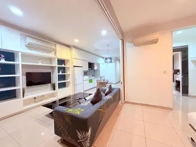 a living room with a couch and a television at Platinum Klcc by StayAura in Kuala Lumpur