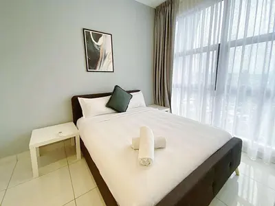 a bed with a white towel on it in a room at Arte Mont Kiara by whitedoorz Apartment in Kuala Lumpur