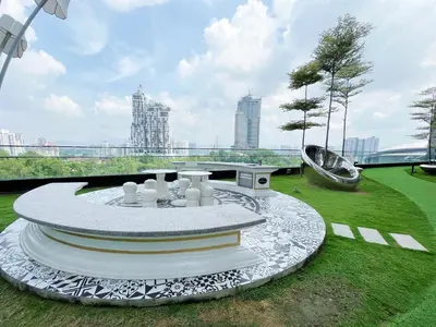 a park with a fountain in the middle of a field at Arte Mont Kiara by whitedoorz Apartment in Kuala Lumpur