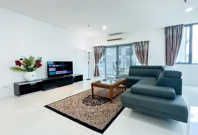 a living room with a couch and a tv at Summer Suites KLCC Vibes in Kuala Lumpur