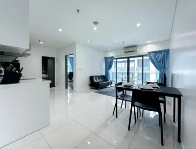a dining room and living room with a table and chairs at Summer Suites KLCC Vibes in Kuala Lumpur
