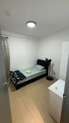 a small room with a bed and a table in it at M Arisa Sentul KL City view in Kuala Lumpur