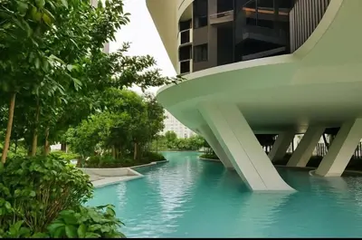 a bridge over a river in a city with trees at M Arisa Sentul KL City view in Kuala Lumpur