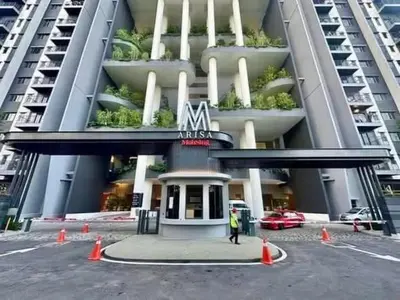 a man standing in front of a building at M Arisa Sentul KL City view in Kuala Lumpur