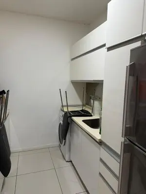 a white kitchen with a sink and a refrigerator at M-City, Jalan Ampang in Kuala Lumpur