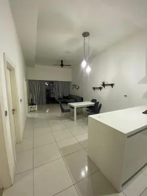 a white living room with a table and chairs at M-City, Jalan Ampang in Kuala Lumpur