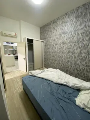 a bedroom with a bed and a wall at M-City, Jalan Ampang in Kuala Lumpur