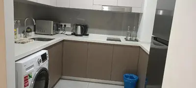 a kitchen with a sink and a washing machine at Homestay at Wyndham Suites KLcc in Kuala Lumpur
