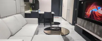 a living room with a white couch and a table at Homestay at Wyndham Suites KLcc in Kuala Lumpur