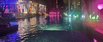 a city street at night with a pool of water at Homestay at Wyndham Suites KLcc in Kuala Lumpur