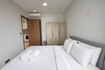 a bedroom with a white bed with two white pillows at Sky Suites KLCC By Sky Management in Kuala Lumpur