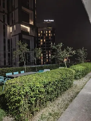 a park with benches and trees in a city at night at Scarletz Suites KLCC Twin Tower by Skyview in Kuala Lumpur