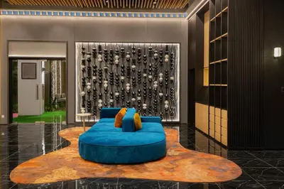 a blue couch in the middle of a lobby at Majestic KLCC By Flora in Kuala Lumpur