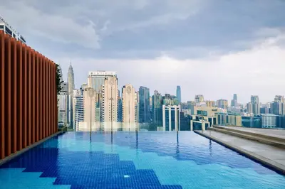 a swimming pool on top of a city skyline at Majestic KLCC By Flora in Kuala Lumpur