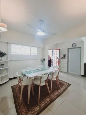 a dining room with a table and chairs in a room at Shahana Homestay KL for musleem in Kuala Lumpur