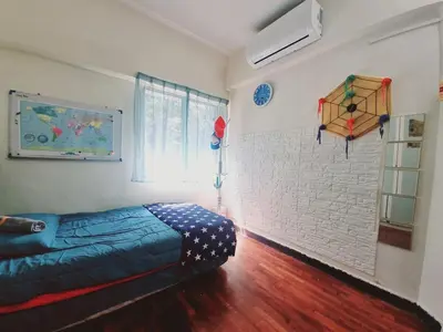 a bedroom with a bed and a kite on the wall at Shahana Homestay KL for musleem in Kuala Lumpur