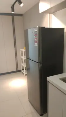 a kitchen with a black and silver refrigerator at The Colony Infinitum KLCC Suits By Sabu in Kuala Lumpur