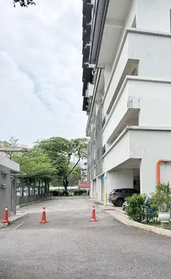 a parking lot with orange cones in front of a building at Happy Homes Kuala Lumpur Rooms in Kuala Lumpur
