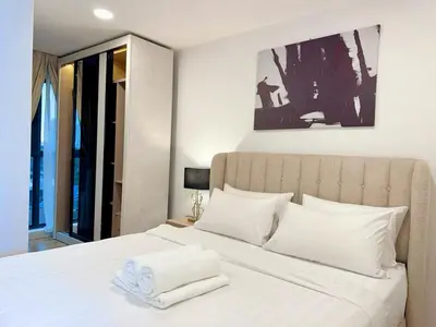 a bedroom with a large bed with white pillows at Premium Executive Family Suites 3Bedroom at The Atrium Ampang by OKBnB in Kuala Lumpur
