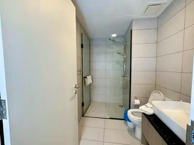 a bathroom with a shower and a toilet and a sink at Premium Executive Family Suites 3Bedroom at The Atrium Ampang by OKBnB in Kuala Lumpur