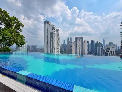a large swimming pool on top of a city skyline at Majestic Unique Studio Suite with Infinity Pool in Kuala Lumpur