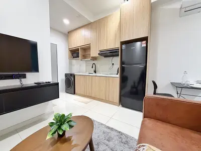 a kitchen with a black refrigerator and a table at Majestic Unique Studio Suite with Infinity Pool in Kuala Lumpur