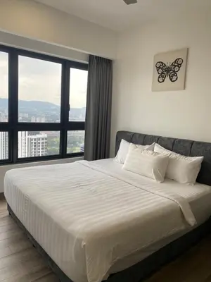 a bedroom with a bed with a butterfly picture on the wall at Agile Bukit Bintang Save Home in Kuala Lumpur