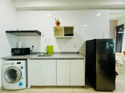 a kitchen with a refrigerator and a washing machine at Arte Plus by Jerry in Kuala Lumpur