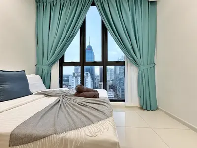 a bedroom with green curtains and a large window at Majestic Wonder Studio Suite with Infinity Pool in Kuala Lumpur