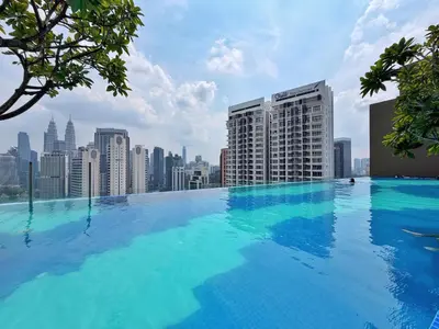 a large swimming pool on top of a city skyline at Majestic Wonder Studio Suite with Infinity Pool in Kuala Lumpur