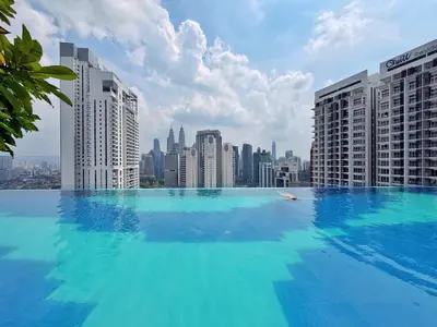 a large swimming pool on top of a city skyline at Majestic Wonder Studio Suite with Infinity Pool in Kuala Lumpur
