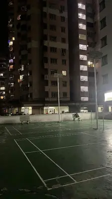 an empty tennis court in a city at night at Homestay in Kuala Lumpur
