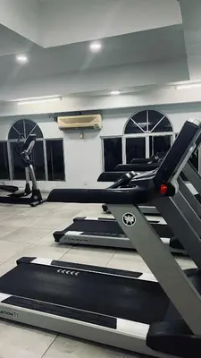 a gym with several tread machines in a room at Homestay in Kuala Lumpur
