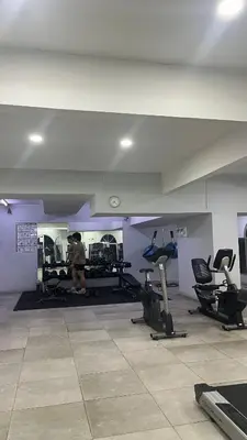 a person in a gym with several exercise equipment at Homestay in Kuala Lumpur