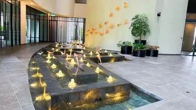 a lobby with a fountain with birds in it at Jalan Ampang KLCC Embassy Area Homestay in Kuala Lumpur