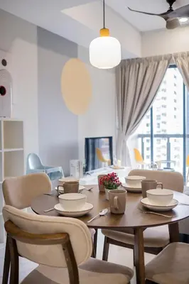 a dining room with a wooden table and chairs at 38 Bangsar by Feel Home in Kuala Lumpur