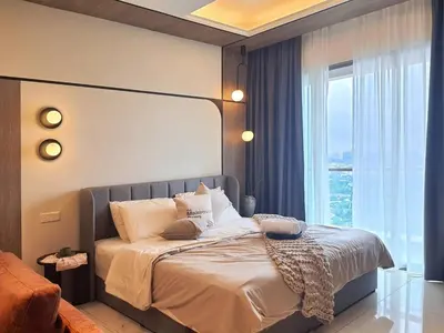 a bedroom with a bed with a large window at Cozy Studio Retreat in Kuala Lumpur