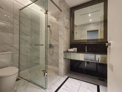 a bathroom with a glass shower and a toilet at Cozy Studio Retreat in Kuala Lumpur