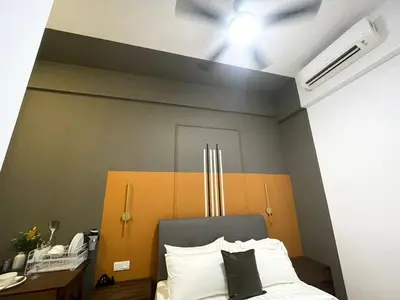 a bedroom with a bed with a gray and orange headboard at Cheapest 2R2B in the Heart of KL in Kuala Lumpur