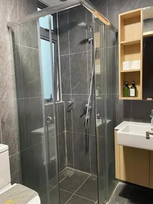 a shower with a glass door in a bathroom at Cheapest 2R2B in the Heart of KL in Kuala Lumpur
