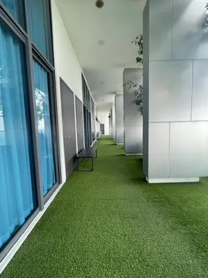 an office hallway with green carpeted floors and windows at The Colony by Klcc Wisma Infinitum in Kuala Lumpur