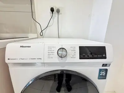 a white washing machine with a box on top at Majestic Calm 1BR Suite with Rooftop Infinity Pool in Kuala Lumpur